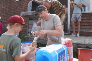 Andrew L'Orsa, chair of the Driftwood Schoolhouse Committee serves scoops of ice cream during a celebration of the Driftwood Schoolhouse on June 21.