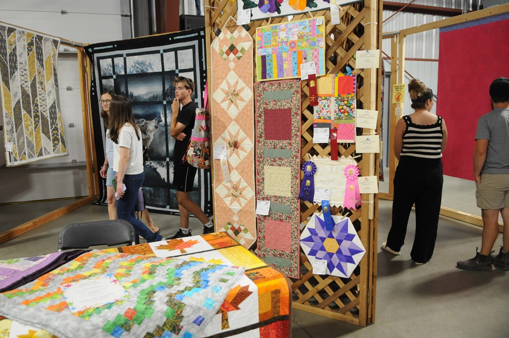 Folks check out quilts on display during the 153rd annual Chilliwack Fair at Chilliwack Heritage Park on Saturday, Aug. 9, 2025.