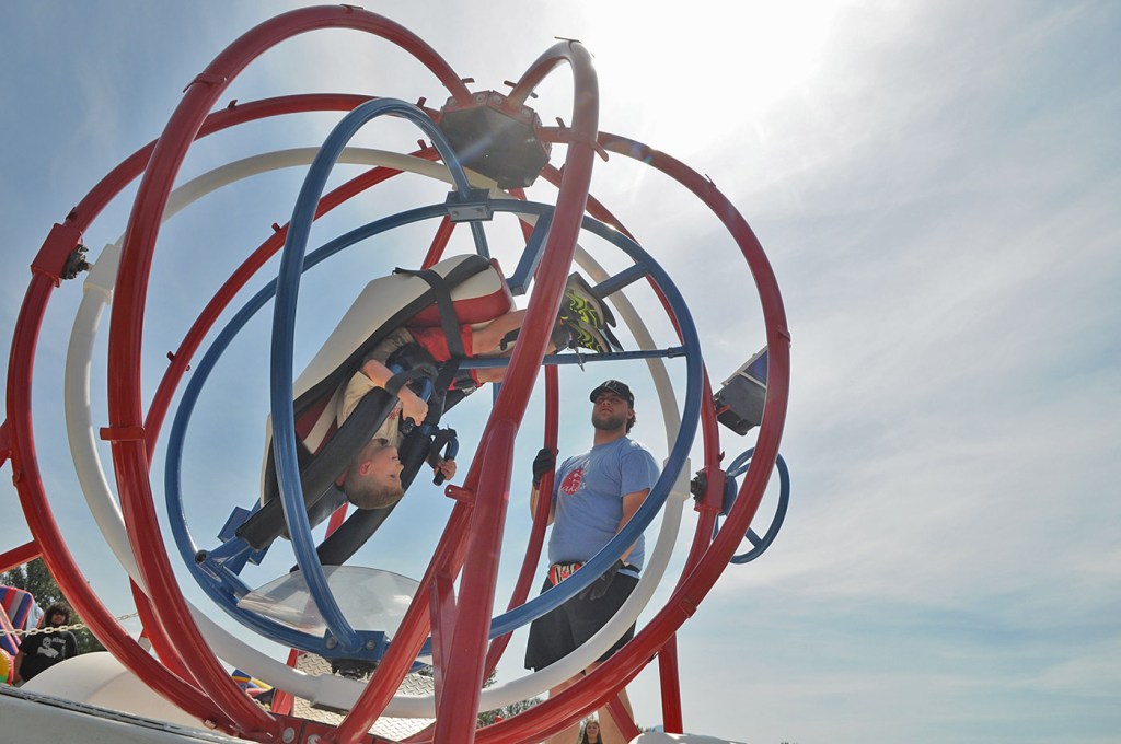 Ben Gunn spins eight-year-old Carter VanDer Kooi around on the Space Ball during the 153rd annual Chilliwack Fair at Chilliwack Heritage Park on Saturday, Aug. 9, 2025.