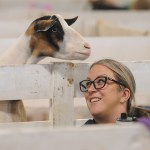 Sarah Pahl of Langley smiles as Captain the goat begs for potato chips during the 153rd annual Chilliwack Fair at Chilliwack Heritage Park on Saturday, Aug. 9, 2025.