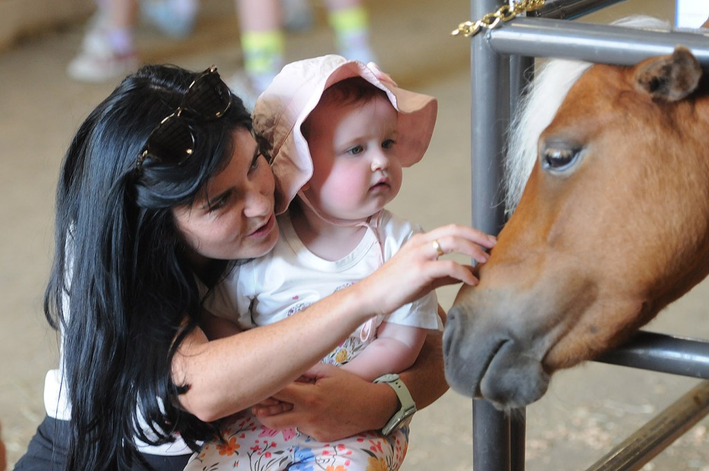 Shannon Brogan and 20-month old daughter Sadie of Vancouver meet a pony during the 153rd annual Chilliwack Fair at Chilliwack Heritage Park on Saturday, Aug. 9, 2025.