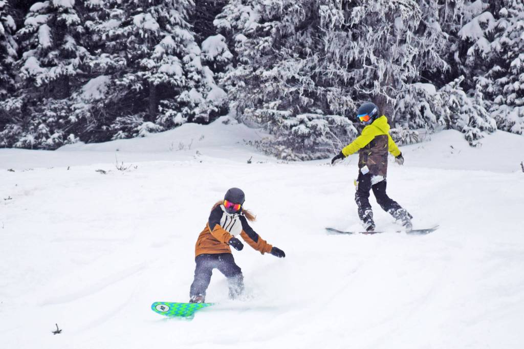 Snowboarders make their way down the hill on the opening day of Hudson Bay Mountain Resort for 2019. (Trevor Hewitt/Black Press Media file photo)