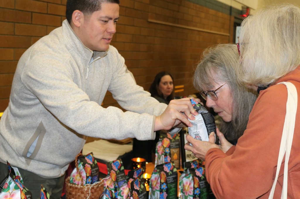 Kear Porttris from Indigenous Roots Coffee Co., talks to visitors at the Oaklands West Coast winter market.