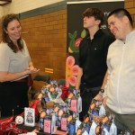 Co-founders of Indigenous Roots Coffee Company Natasha Parrish (Sk'ing lúudas) and Kear Porttris, with nephew Joshua Josok, showcase products at the Oaklands West Coast winter market.