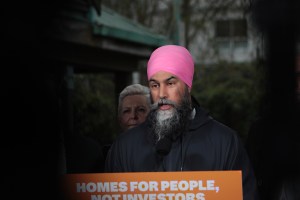 Federal NDP Leader Jagmeet Singh speaks in Vancouver on Tuesday, April 8, 2025, with Port Moody-Coquitlam MP incumbent Bonita Zarillo in the background, detailing his party's plan for a permanent ban on foreign buyers.