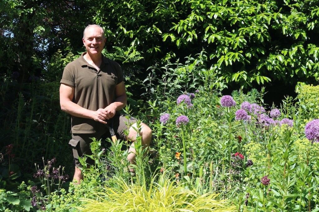 Fairmont Empress Hotel gardener Alex Buck tends to the plants in the Centennial Garden, home to Roger the marmot.