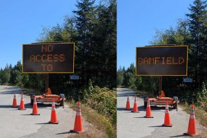 A sign along Franklin River Road states 'wildfire ahead no access to Bamfield.' A section of the road is unsafe for drivers to travel on due to damage the wildfire has caused to the area.