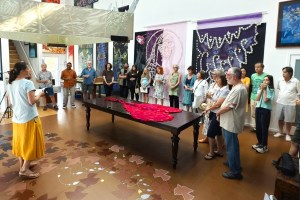Artists gather for a meeting about their work being featured in Europe.
