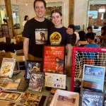 Vernon's Chad Soon (left), with daughter, Jasmine, promotes Vernon's  Larry Kwong's story at the 2025 Okanagan Asian Culture Festival on Aug. 30 in Kelowna. Soon co-authored the non-fiction children's book at centre of the photo, The Longest Shot: How Larry Kwong Changed the Face of Hockey, which has been shortlisted for two major Canadian literary awards.