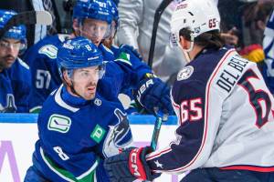 Vancouver Canucks forward Conor Garland, left, battles with Columbus Blue Jackets forward Luca Del Bel Belluz during NHL action Saturday, Nov. 8, 2025 at Rogers Arena in Vancouver. (https://x.com/Canucks photo)
