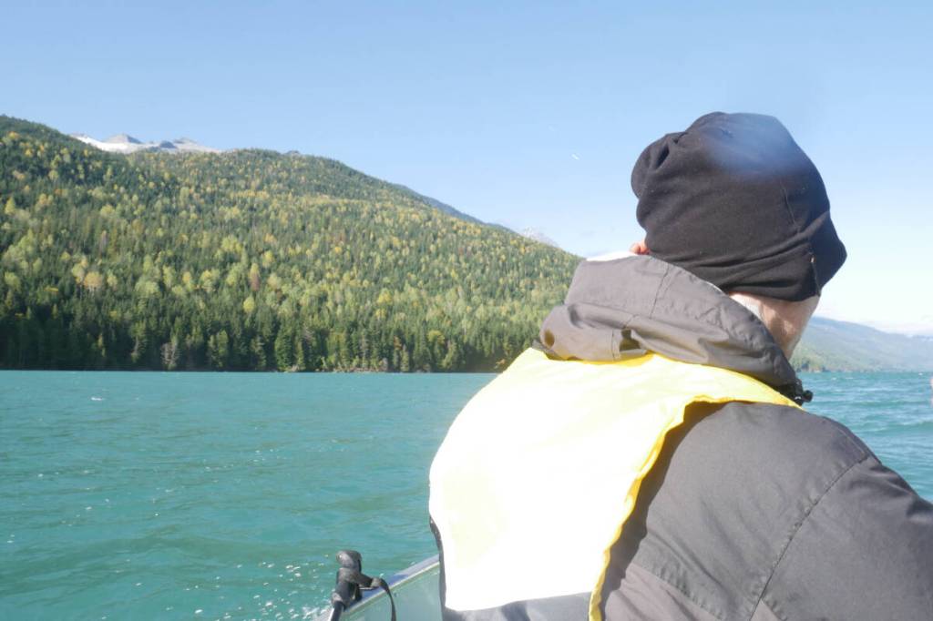 Václav Kuželka at boat&rsquo;s bow on the way across Lake Revelstoke to the Rainbow-Jordan Wilderness, pictured off to the left Oct. 9, 2025. (Evert Lindquist/Revelstoke Review)