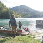 From left, Tyler McKendry, Valhalla Wilderness Society biologist Amber Peters, her dog Akash and Václav Kuželka prepare a boat at Carnes Creek to access the Rainbow-Jordan Wilderness via Lake Revelstoke, pictured Oct. 9, 2025. (Evert Lindquist/Revelstoke Review)