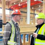 Chris Kalesnikoff (L) explains the mass timber production process to energy minister Tim Hodgson (R) on a tour of the Kalesnikoff facility on Nov. 10. (Betsy Kline/Castlegar News)