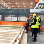 Chris Kalesnikoff (L) explains the mass timber production process to energy minister Tim Hodgson (R) on a tour of the Kalesnikoff facility on Nov. 10. (Betsy Kline/Castlegar News)