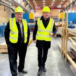 Ken Kalesnikoff (L) talks to Stephen Fuhr (R), the secretary of state (defence procurement) at Kalesnikoff Mass Timber. (Betsy Kline/Castlegar News)