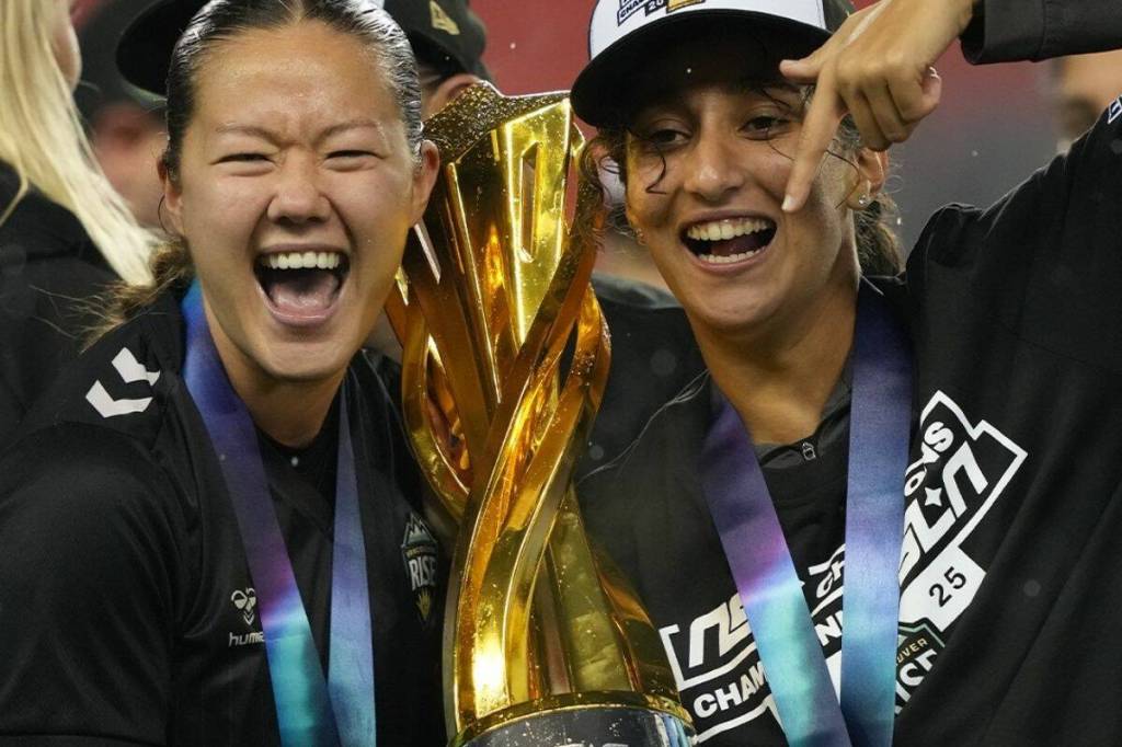 Samantha Chang, left, and Anais Oularbi pose for a photo with the Diana B. Matheson Cup at BMO Field in Toronto, Saturday (Nov. 15). (Northern Super League/ Facebook)