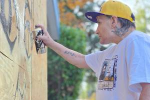 Graffiti artist Smokey Devil at work on the Brookswood memorial to Breallan Dawne Franks. Dan Ferguson/Langley Advance Tmes)
