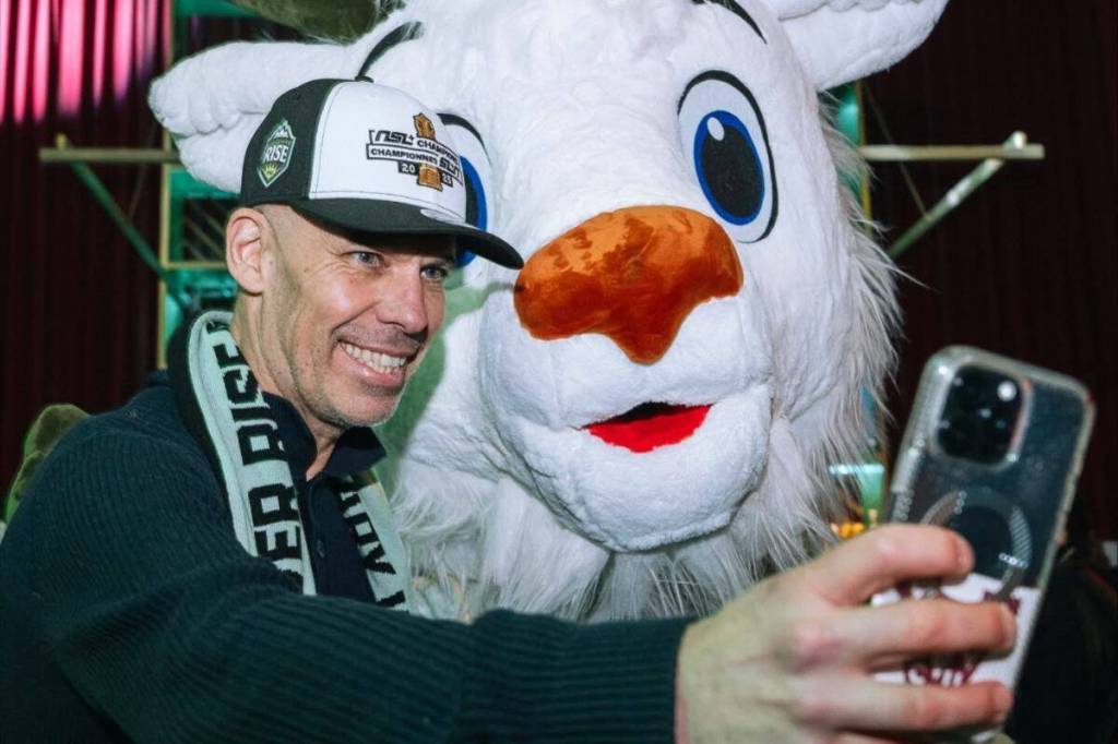A Fan poses for a photo with Rise FC mascot, Sunny the mountain goat, at the Hollywood Theatre in Vancouver on Nov. 20, 2025. (Vancouver Rise FC/ Facebook)