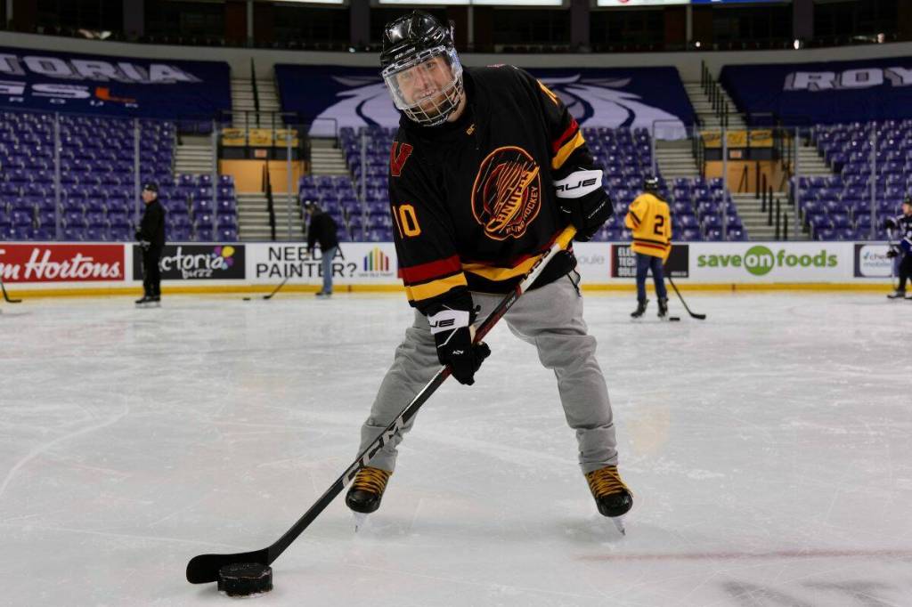 Corbin Johnson, program coordinator for the Canadian Blind Hockey Association, poses with a blind hockey–specific puck. (Tony Trozzo/Victoria News)
