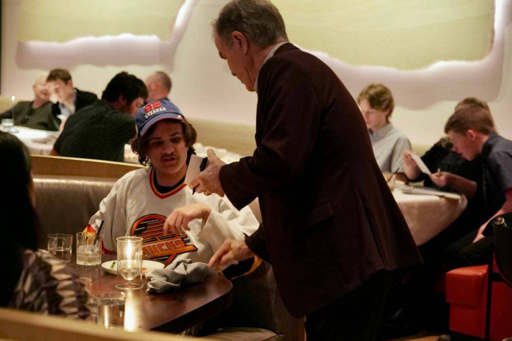 Darcy Rota walks around the restaurant, signing autographs for members of the South Island Ravens. (Tony Trozzo/Victoria News)