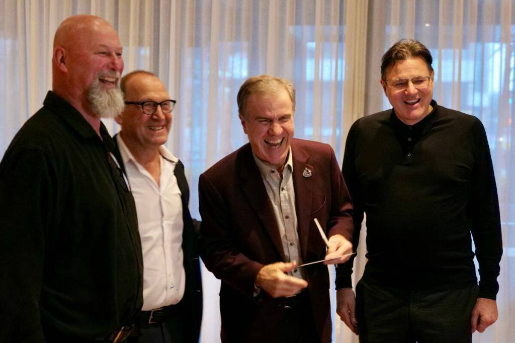 Gus Ascroft, Stan Smyl, Darcy Rota and Francesco Aquilini share a laugh during the cheque presentation on Tuesday. (Tony Trozzo/Victoria News)
