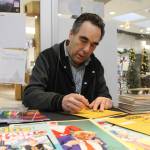 Richard Comely, creator of Captain Canuck, signs autographs at Curious Comics on Wednesday, Nov. 26. (Jessica Durling/News Bulletin)
