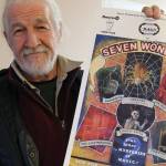 Guy Simmons with a 1991 poster advertising the Magic Alliance in Seven Wonders. (Ben Fenlon/Sooke News Mirror)