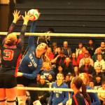 Hayden Molitwenik of the Vernon Panthers (left) reaches up to block a kill attempt from Carys Scott of the Seaton Sonics in the all-Vernon quarterfinal at the B.C. High School Senior Girls AAA Volleyball Championships Friday, Nov. 28, at VSS. The Panthers swept the Sonics 3-0 to advance to the final four. (Roger Knox - Morning Star)