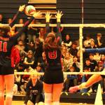 Seaton Sonics captain Brielle Johnson (right) powers her kill through the double block of Deelah Arnold (11) and Lena Hoard of the Vernon Panthers during the all-Vernon quarterfinal match at the B.C. High School Senior Girls AAA Volleyball Championships Friday, Nov. 28, at VSS. The Panthers swept their rivals 3-0 to advance to the semifinals Saturday. (Roger Knox - Morning Star)