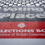 An Elections B.C. sign is seen covered in rain on election day in Vancouver, on Saturday, October 19, 2024. Polls are now open in British Columbia, where voters in today's provincial election face a choice that would have been unthinkable just a few months ago. THE CANADIAN PRESS/Ethan Cairns