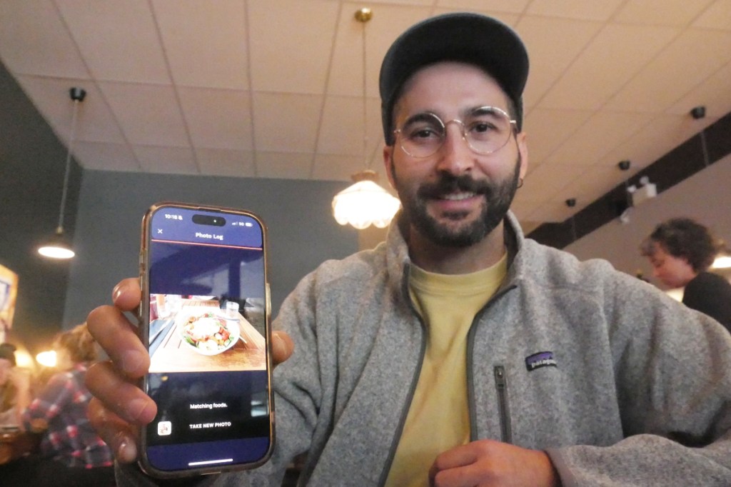 Cronometer product team manager Brendan Benson shows the app's newest feature, a meal scanner for assessing nutritients, at Revelstoke's Flourish Bakery on Friday, Sept. 26.