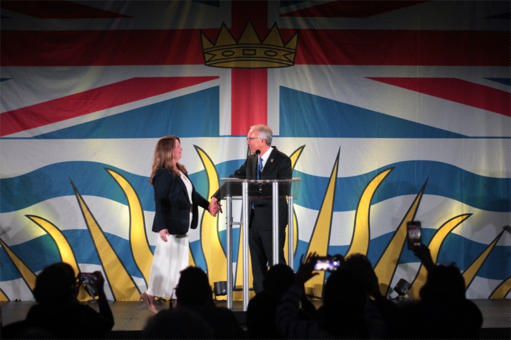 Conservative Party of B.C. Leader John Rustad welcomes his wife, Kim, on stage for his speech at the party's election night headquarers. He credited her for taking on the Conservative leadership.