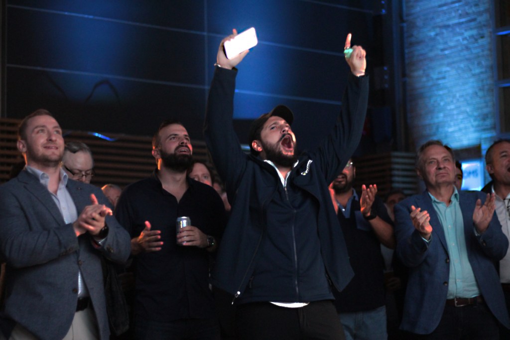 Conservative Party of B.C. supporters cheer on candidates as they're shown to be in the lead during the election night party in Vancouver on Saturday, Oct. 19, 2024.