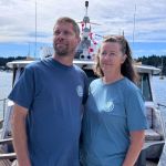 Blaine and Janis Carmena on the bow of their boat, Tangaroa.