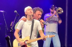 Surrey resident Jackson Newson (in hat) with Arkells singer Max Kerman on stage at Barnside Harvest Festival in Ladner on Saturday, Sept. 13, 2025.