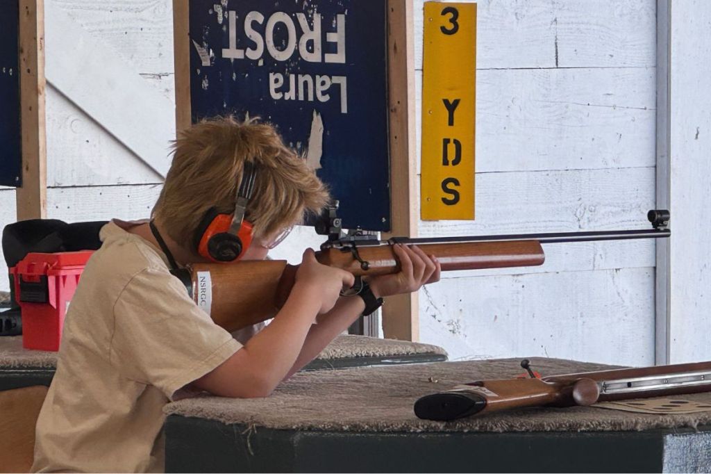 A young shooter is getting ready to fire a rifle downrange. Harry Corro/Peninsula News Review