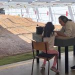 A girl is getting ready to shoot her rifle downrange with one of the NSRG coaches.