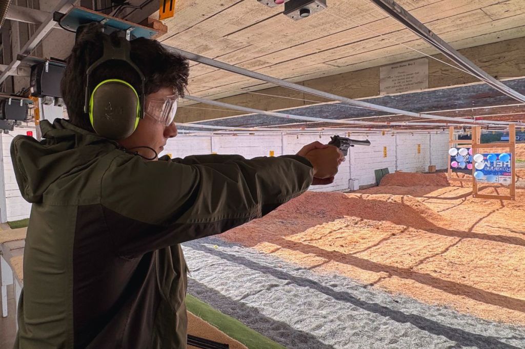 Ryan Fathi shoots at a range with balloon targets.