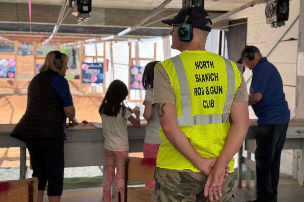 North Saanich Rod & Gun Club coaches making sure the girls are prepped before jusing the pistols on Bay 2. Harry Corro/Peninsula News Review
