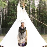A Horse Lake Elementary School student stands in a small teepee at Horse Lake Elementary School. (Patrick Davies photo - 100 Mile Free Press)
