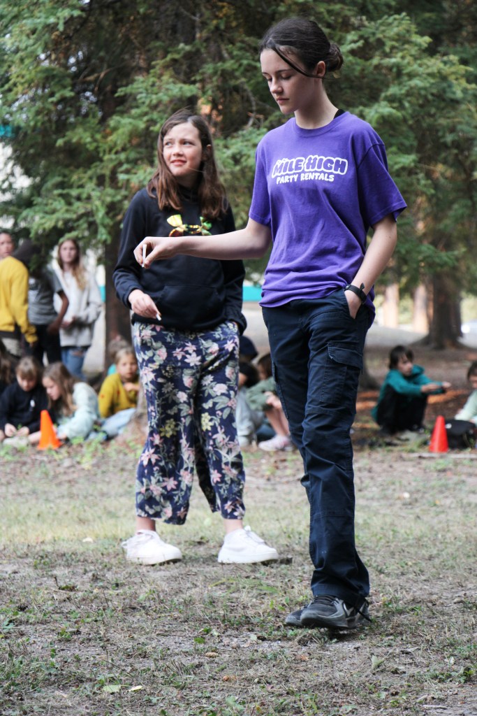 Horse Lake Elementary School students  Kiera Bracey and Freddie Boutilier sprinkle tobacco on the grounds of their school ahead of the construction of a teepee. (Patrick Davies photo - 100 Mile Free Press)