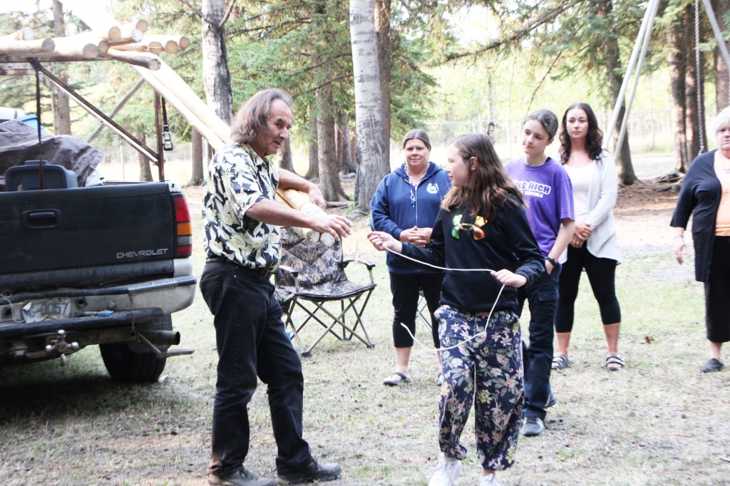 Tony Solomon directs Kiera Bracey on how to build a teepee at Horse Lake Elementary School. (Patrick Davies photo - 100 Mile Free Press)