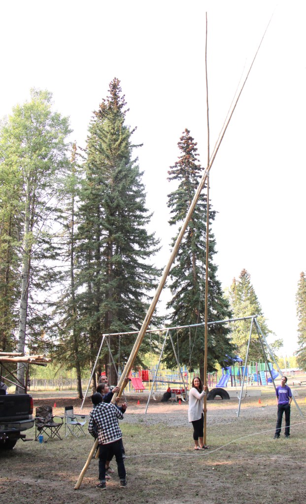 Staff of Horse Lake Elementary School work together to build a teepee at Horse Lake Elementary School. (Patrick Davies photo - 100 Mile Free Press)