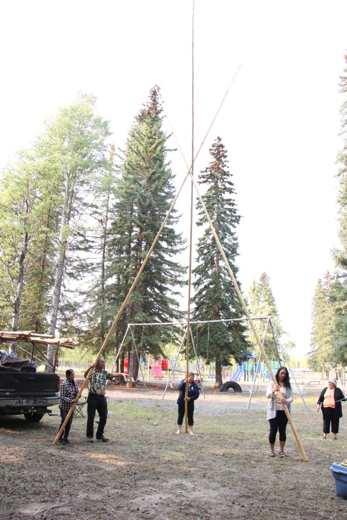 Staff of Horse Lake Elementary School work together to build a teepee at Horse Lake Elementary School. (Patrick Davies photo - 100 Mile Free Press)
