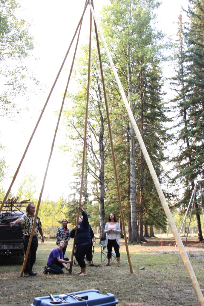Staff of Horse Lake Elementary School work together to build a teepee at Horse Lake Elementary School. (Patrick Davies photo - 100 Mile Free Press)