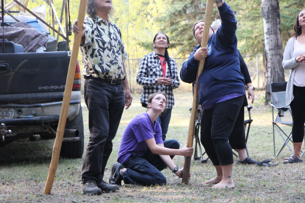 Staff and students of Horse Lake Elementary School work together to construct a teepee on Wednesday, Sept. 17. (Patrick Davies photo - 100 Mile Free Press)