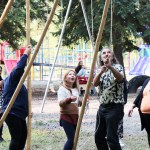 Avery Finlayson watches as Tony Solomon tugs on a tope to secure some teepee poles together at Horse Lake Elementary School. (Patrick Davies photo - 100 Mile Free Press)