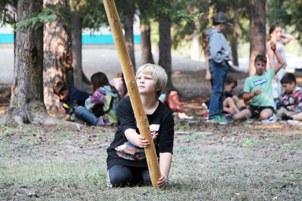 Horse Lake Elementary School student Colter Bishop holds a teepee pole in place on Wednesday, Sept. 17. (Patrick Davies photo - 100 Mile Free Press)