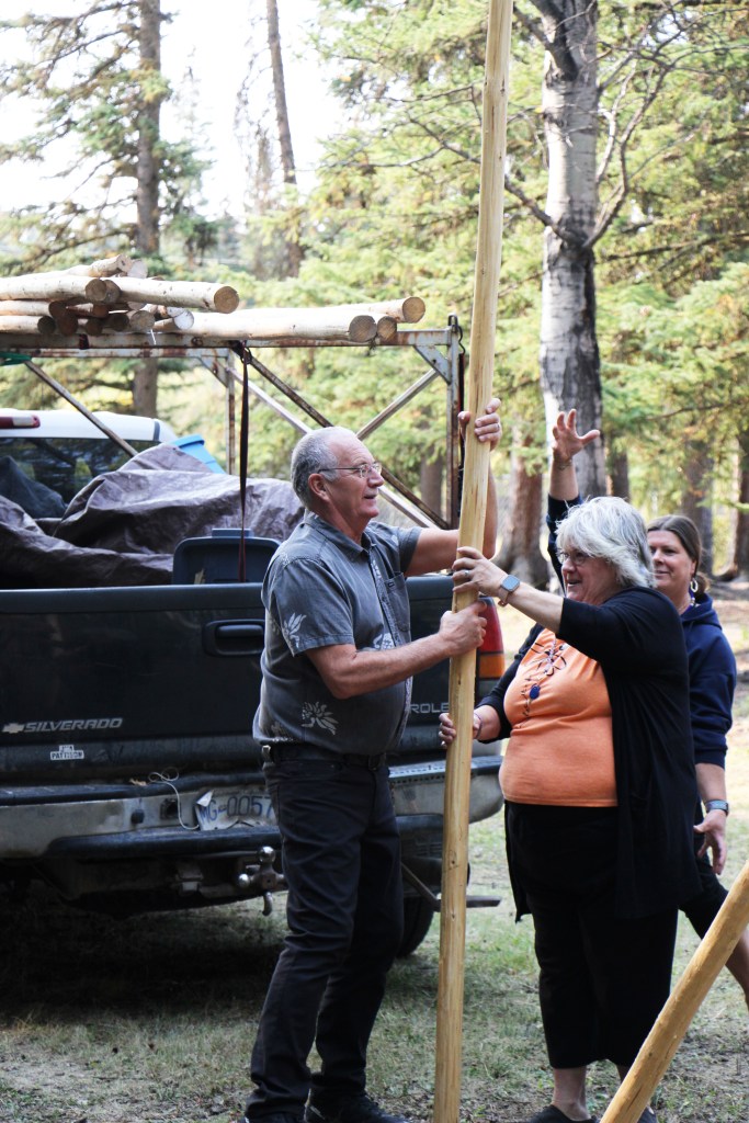 Horse Lake Elementary School principal Murray Helmer and indigenous support worker Jodi Thomson work together to build a teepee. (Patrick Davies photo - 100 Mile Free Press)