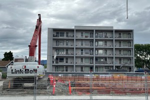 Items can be seen left behind on the balconies of Hadgraft Wilson Place after residents were evacuated on April 2, 2024 due to structural damage caused by neighbouring construction of the UBCO downtown Kelowna campus. Construction of the campus can be seen in the foreground.
